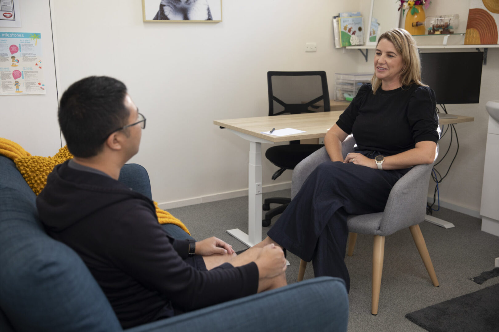Speech pathologist with adult client talking
