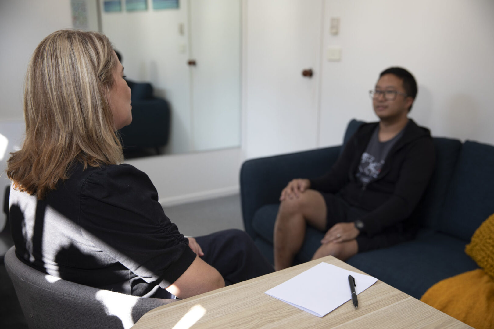 Speech pathologist talking with adult client
